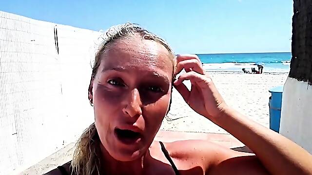 Outdoor solo masturbation scene with curly blonde