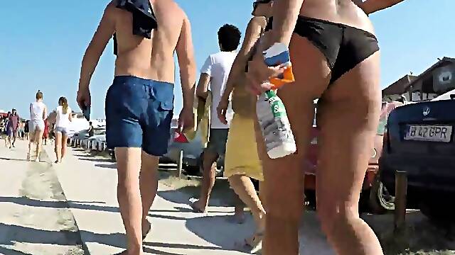 Beach voyeur follows sexy slender babe in tight bikini
