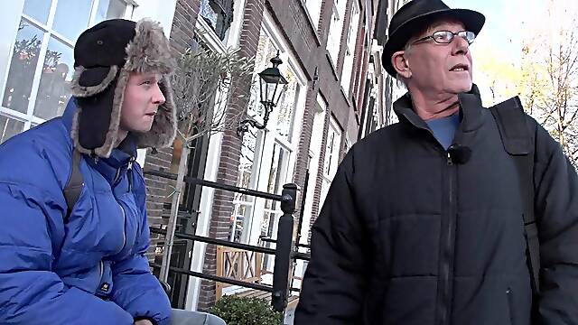He visits the red light district and picks out a hot hooker